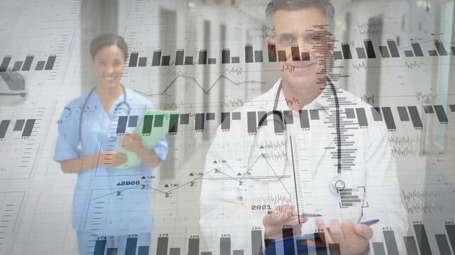 Doctor tapping clipboard and nurse steadying folder in ward causing data charts for patient care