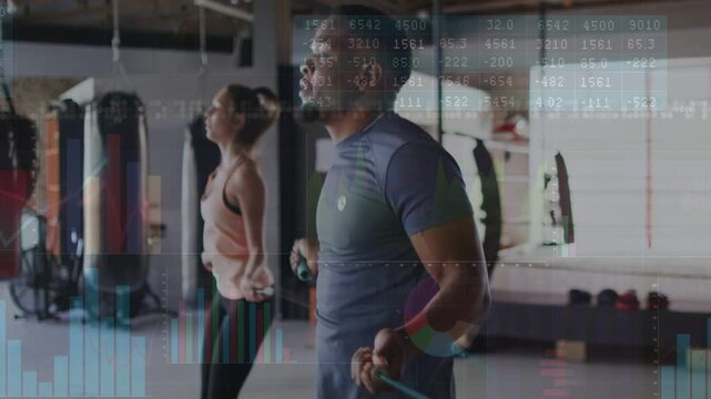Man and woman starting skipping in gym, data charts overlaying jump ropes, showing cardio metrics