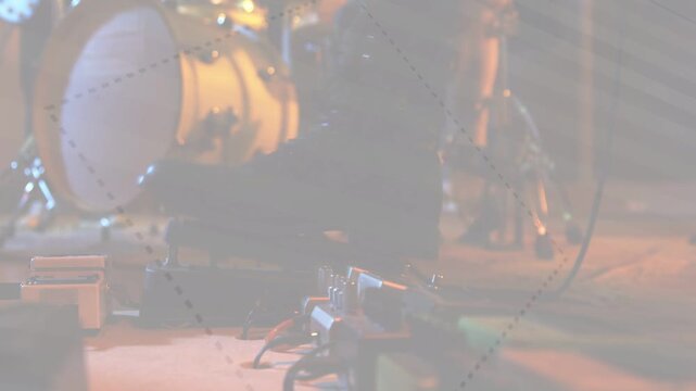 Pedalboard and drums sitting, lighting shifting for music, dotted overlay drifting across gear