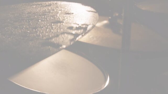 Wet metal cymbal on left revealing beads as camera focus shifting glitch sweeping for music visuals