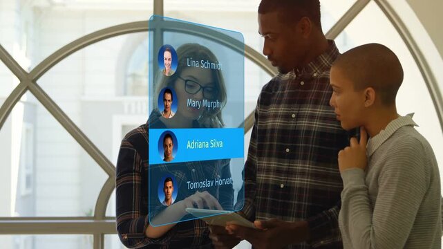 Business team tapping holographic contacts, tablet supporting highlight selecting Mary Murphy