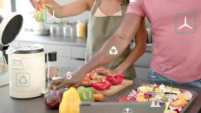 Couple placing board and veg, prepping meal, tossing peels into compost as green icons floating