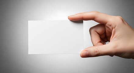 Fototapeta premium Mockup Logo Mockup Hand holding a blank white business card against a gradient image photo