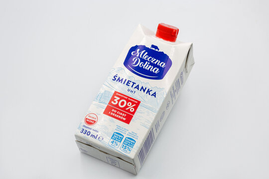 Mleczna Dolina cream 30 percent fat carton package closeup on white.