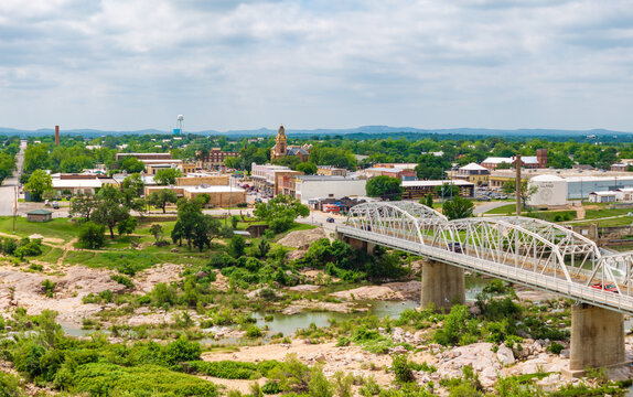 Aerial shot of Ford Street bridge and downtown Llano, Texas Hill Country. Drone point of view captures the panoramic scene