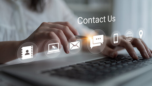 A close-up view of hands typing on a laptop keyboard with contact us icons displayed prominently, representing modern customer engagement and digital communication. Gantry
