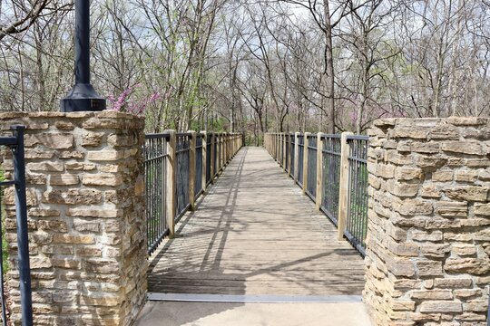 The footbridge in the park on a sunny day.