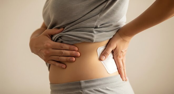 A person's side with a white patch applied to the skin, possibly for pain relief or medical treatment.