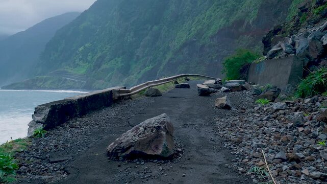 Damaged coastal road blocked by a rockslide in madeira