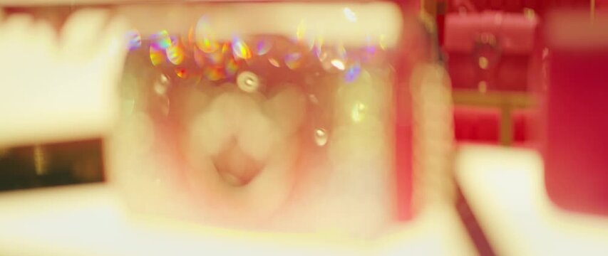 Abstract blurred close-up of luxury jewelry and sparkles inside a fashion shop in Milan