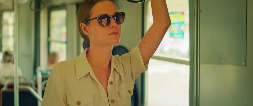 Woman commuting on a tram in Milan city during a sunny summer day in Italy