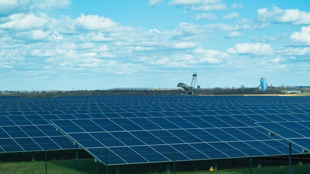 Solaranlage vor einem Braunkohle Tagebau mit Blick auf einen Bagger