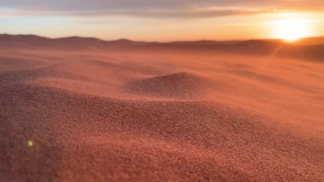 Sand blowing over dunes in wind, sandstorm in Sahara desert, close up Selective focus