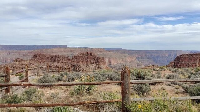 Scenic panoramic view of the Grand Canyon West Rim in Arizona, USA. Desert landscape with layered red rock cliffs, deep canyon formations, Colorado River view. A road trip near Eagle and Guano Point.