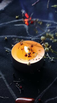 Vertical video, Witch hands burning herbs for a black magic ritual with the help of magical altar, candles and crystals. Sorcerer rite of witchcraft and occultism. Halloween concept