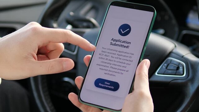 Close-up of a person submitting a citizenship application via smartphone in a car. Successful confirmation screen shown. Ideal for immigration services, government programs, and legal reform visuals