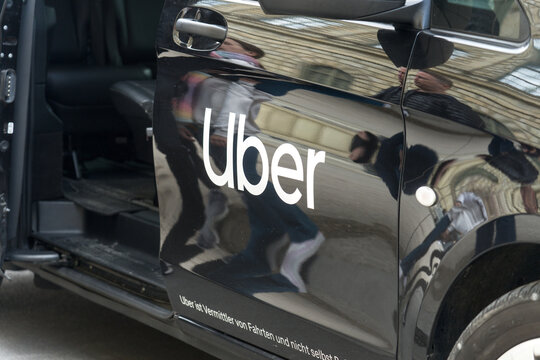 Black Uber car with reflective surfaces and open door