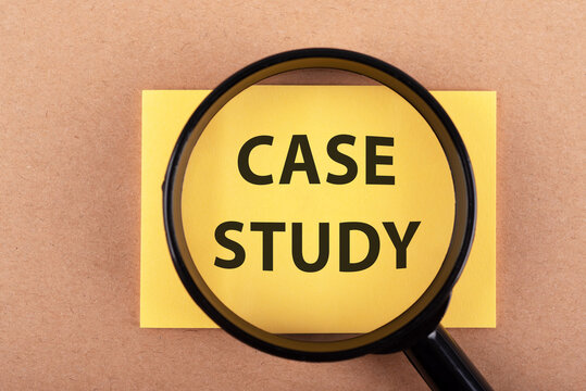 Magnifying glass and case study text on adhesive note