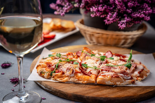 Artisan flatbread pizza with salami cheese and herbs