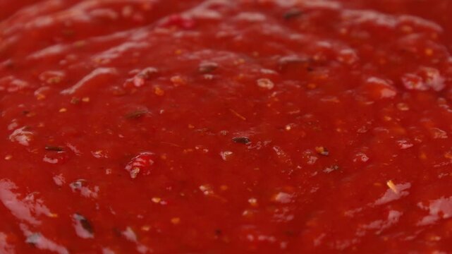 Red Arrabbiata sauce texture circle rotation close up