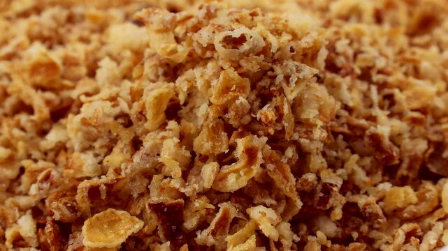 Organic crispy fried onions falling down close up