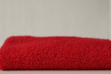 Close up of a vibrant red soft teddy bear fabric with a shallow depth of field. Professional textile background with bokeh for fashion design sewing and winter clothing marketing concepts.  © LadyLensArt 