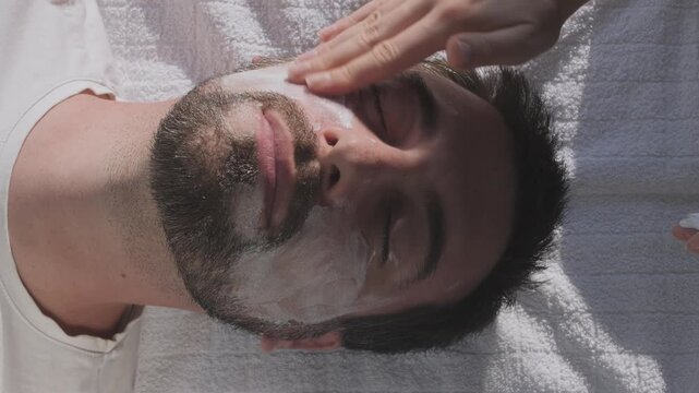 Man is undergoing a cosmetic facial peeling procedure
