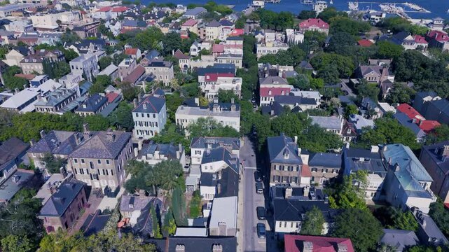 CHARLESTON, SOUTH CAROLINA, USA - APRIL 10, 2026: Aerial-Flying over residential area to waters of Charleston harbor