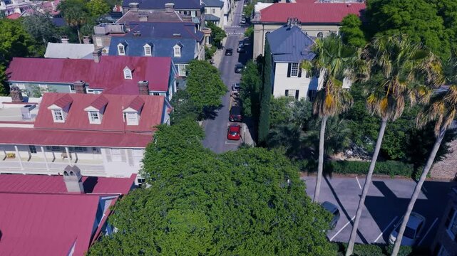 Aerial - Flying low over grand old historic homes on a residential street in Charleston, South Carolina