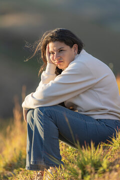 Young woman feeling sad and bored outdoors