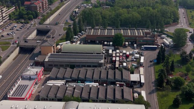 Aerial View of Industrial Zona: An expansive aerial perspective reveals a bustling industrial area, where various activities converge amid the framework of modern infrastructure. 