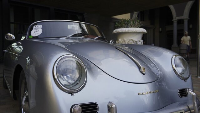 Maspalomas, Las Palmas, Canary Islands, Spain - April 13, 2024 - Silver Porsche 356 vintage roadster showing classic automotive design details and craftsmanship at an exclusive gathering