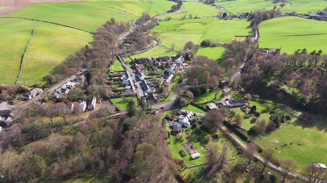 Quiet morning over Eddleston village in the Scottish Borders with stone houses nestled in the lush green valley of Tweeddale.