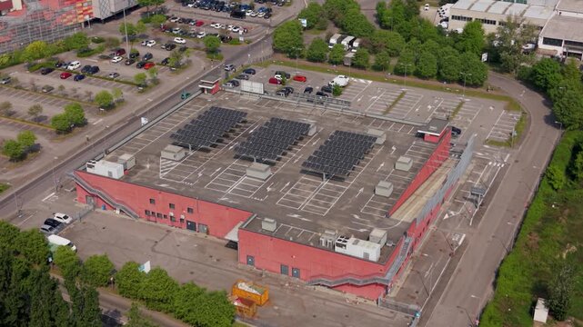 Industrial Urban Landscape: Capturing an aerial perspective, the image highlights a sprawling industrial complex surrounded by parking areas, and patches of verdant greenery.