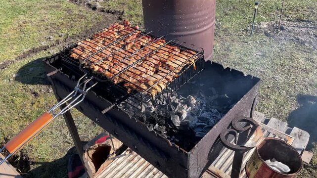 Weekend barbecue setup with metal cage and smoky ambience