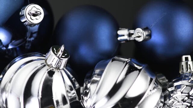 Christmas and New Year blue and silver color baubles decoration background. Art design backdrop with holiday balls. Beautiful Christmas ball macro shot. 
