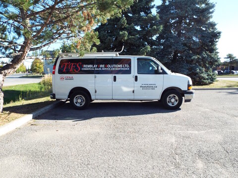 Nepean, Ontario, Canada &ndash; July 27, 2025: A white "Tremblay Fire Solutions van" is parked in a lot beside a tree in a Nepean business park area on Antares Dr.