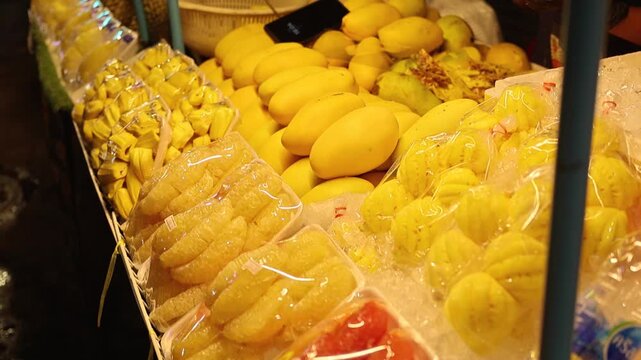 Thailand street market fresh mango sliced packaged tropical fruit display