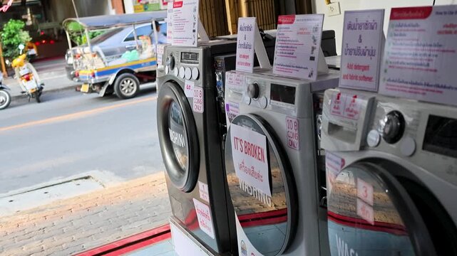 Thailand street laundromat washing machines storefront urban daily life transportation scene