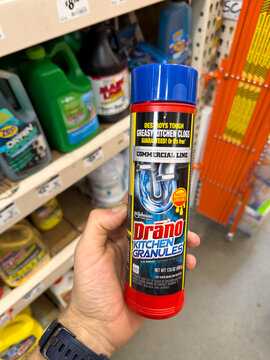 Drano Kitchen Crystals Drain Cleaner Container Held In Hand In Store Aisle
