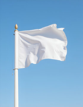 White flag waving on flagpole against clear blue sky