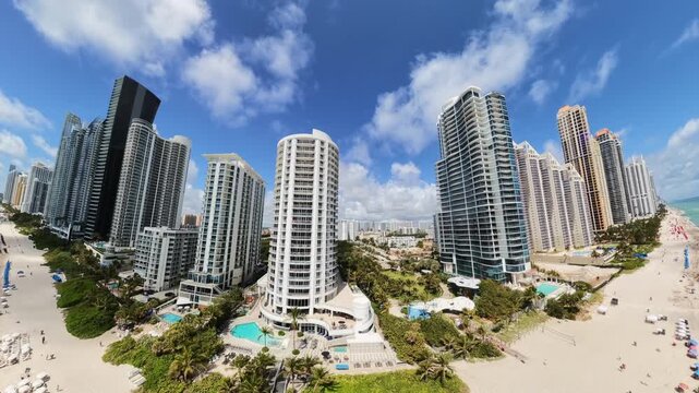 Fisheye aerial video highrise towers on the beach