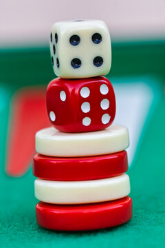 Pyramid of Gaming Dice and Checkers on Backgammon Board Surface game board play entertainment