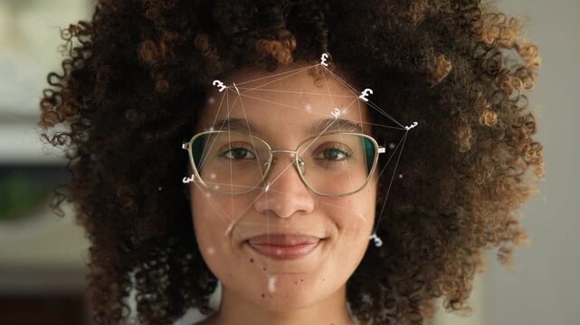 Woman facing camera, smiling and laughing as face mesh overlay appears over glasses showcasing tech