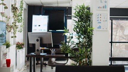 Naklejka premium Empty coworking space with desks and computers, professional agency offices and workstations in business department. Modern company building interior, executive profession.
