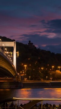 Budapest city skyline timelapse during blue hour featuring the Elisabeth Bridge and Gellert Hill with moving clouds and river traffic