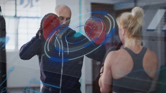 Coach shifting red mitts, cueing trainee throwing jabs for timing, blue HUD syncing with mitts