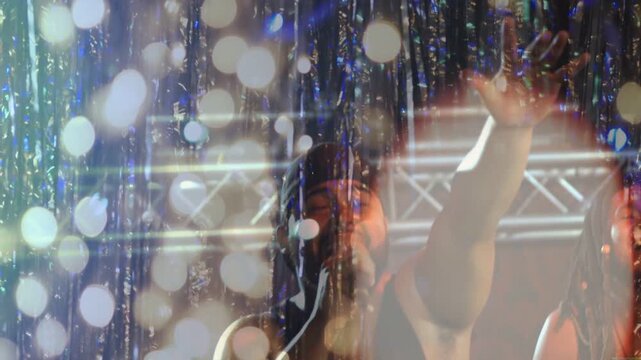 Lead male vocalist emerging through bokeh to mic, backing singer harmonizing, engaging music fans