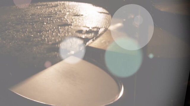On third frame wet cymbal shimmering while bokeh circles drifting, washing amber to reveal metal
