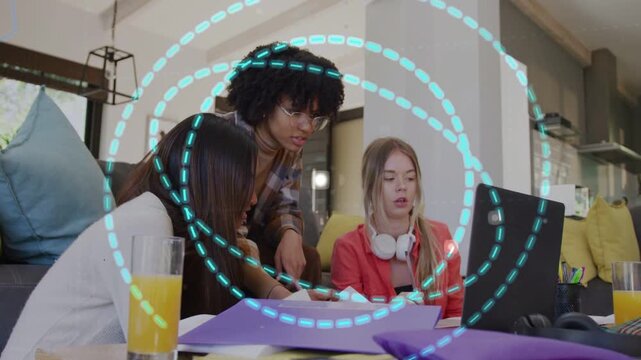Three students leaning, lead student pointing, causing blue dotted rings over laptop for study